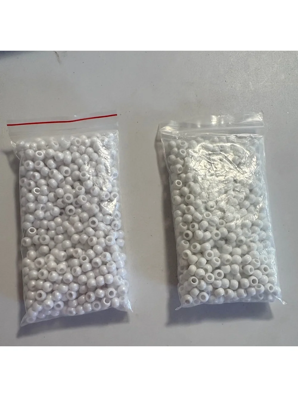 Two bags of white beads